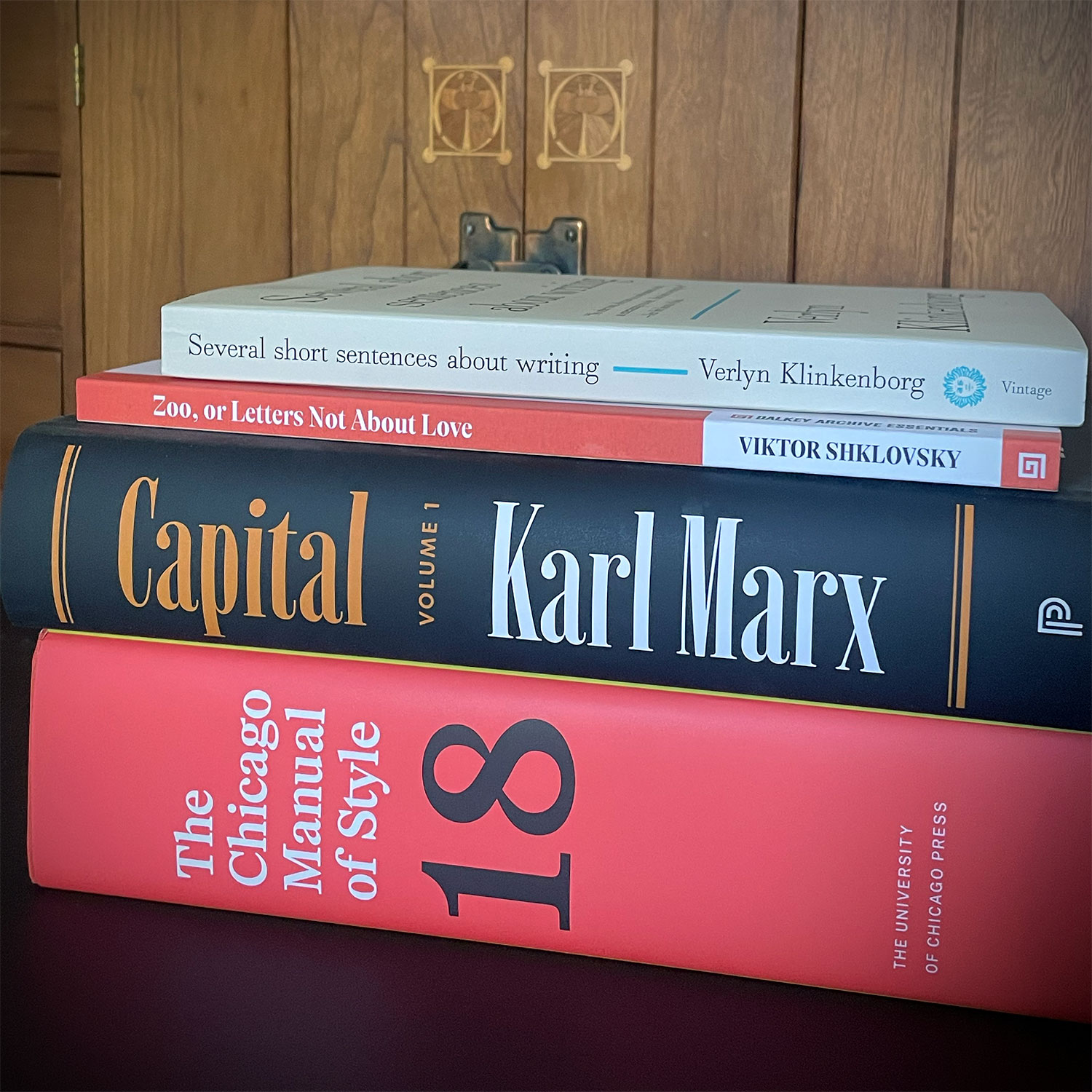 A stack of books, including a new translation of Capital and the new edition of the Chicago Manual of Style